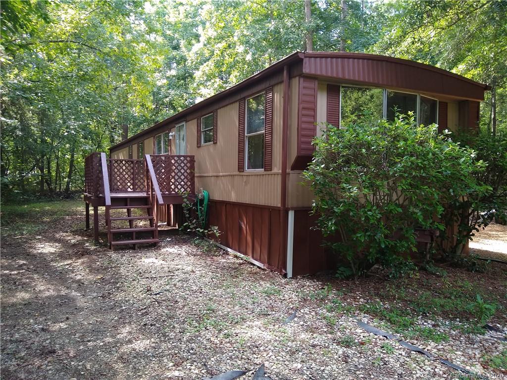 10116 Robert Bost Road Midland, NC 28107 - Photo 3 of 33 a view of a house that has a small yard and a large tree