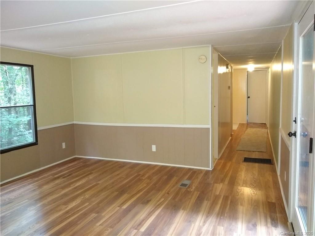 10116 Robert Bost Road Midland, NC 28107 - Photo 26 of 33 a view of an empty room with wooden floor and a window
