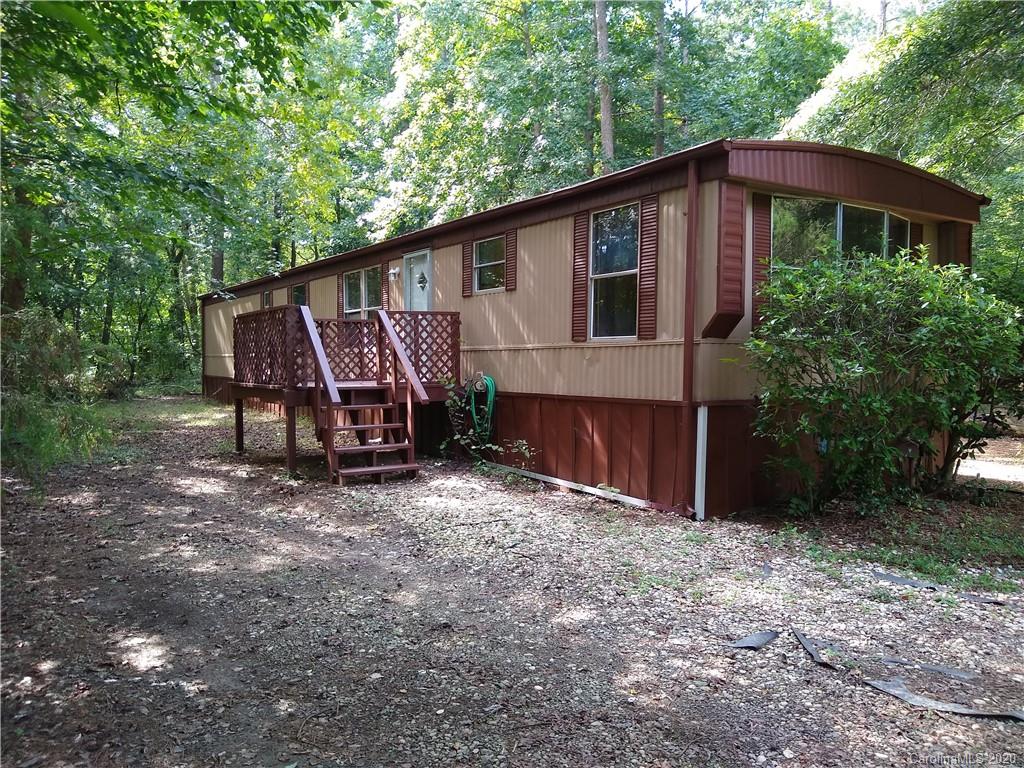 10116 Robert Bost Road Midland, NC 28107 - Photo 4 of 33 a view of a small house with a yard and large tree