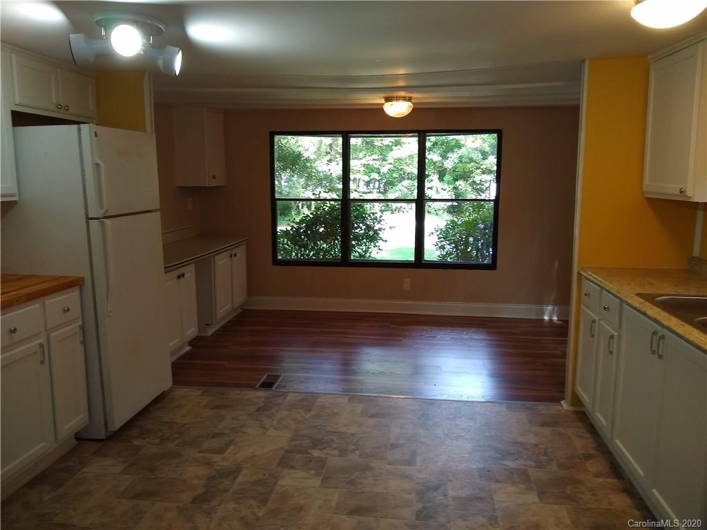 10116 Robert Bost Road Midland, NC 28107 - Photo 9 of 33 a view of a kitchen with wooden floor and a refrigerator