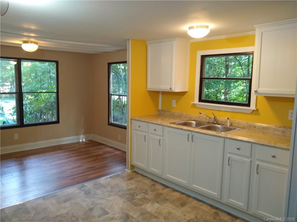 10116 Robert Bost Road Midland, NC 28107 - Photo 10 of 33 a view of a kitchen with wooden floor and a sink