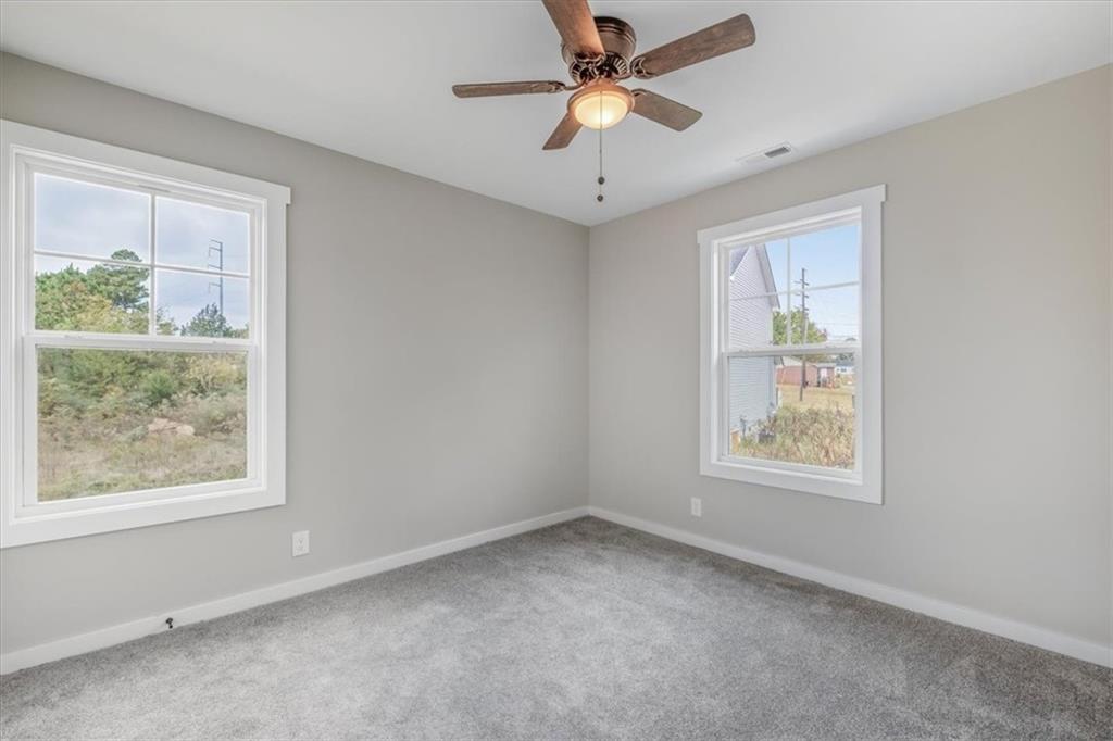 100 Hixville Road Aragon, GA 30104 - Photo 18 of 26 an empty room with windows and ceiling fan