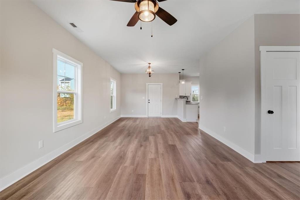 100 Hixville Road Aragon, GA 30104 - Photo 2 of 26 a view of empty room with wooden floor and ceiling fan