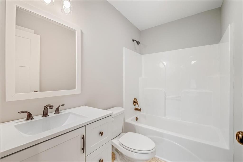 100 Hixville Road Aragon, GA 30104 - Photo 23 of 26 a bathroom with a bathtub shower sink vanity mirror and toilet