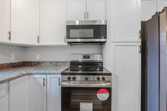 a stove top oven sitting inside of a kitchen