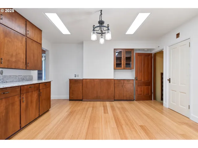 a view of a kitchen with wooden floor and a kitchen