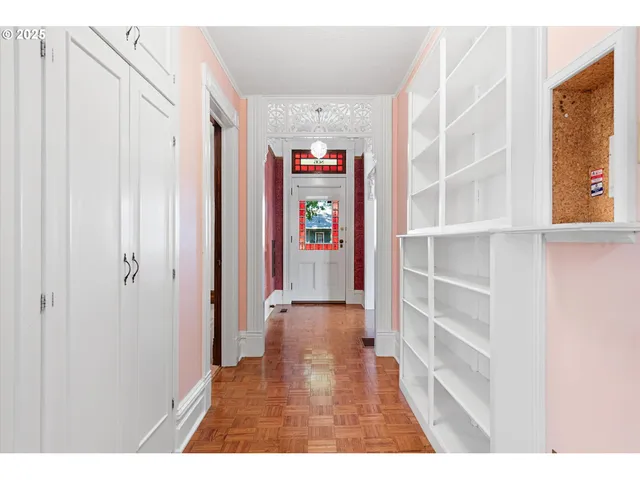 a view of an empty room with window chandelier