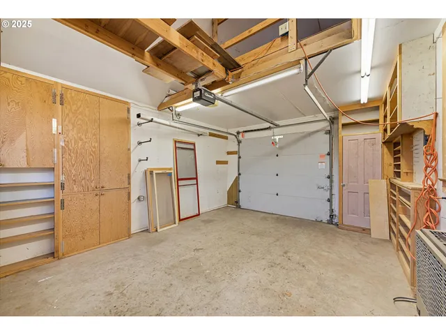 a view of a house with backyard and a tree
