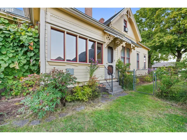 a view of house with backyard space and garden