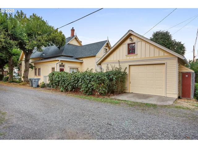 a view of a house with a yard and garage