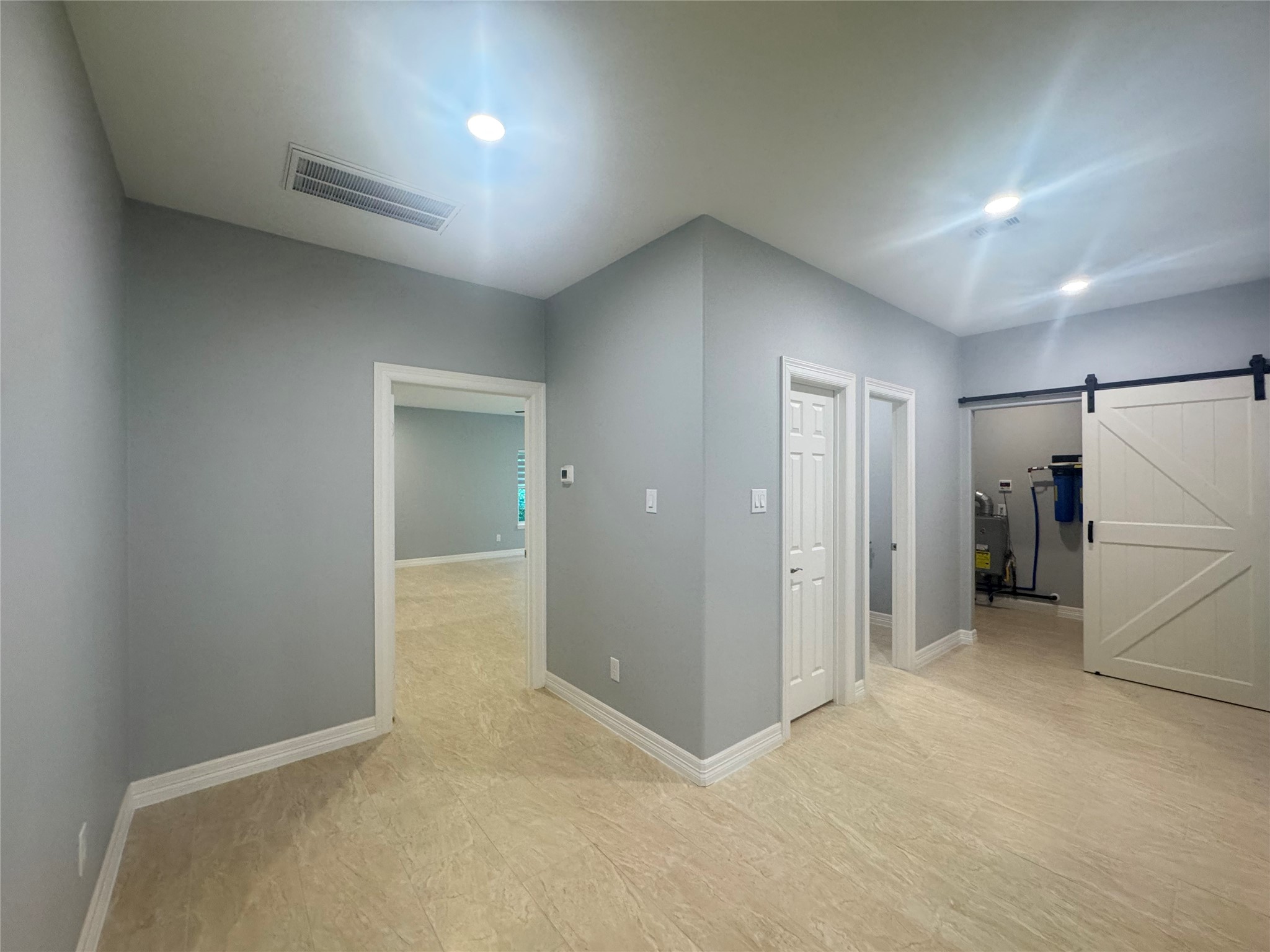 2010 Cherry Laurel Spring, TX 77386 - Photo 20 of 45 Hallway leading to primary bedroom on left, powder room and utility room to the right