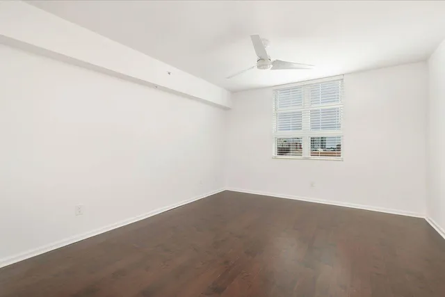 an empty room with windows and closet