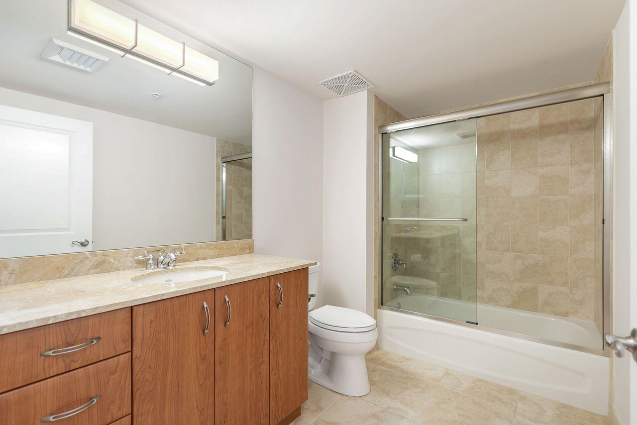 403 South Sapodilla Avenue, Unit 509 West Palm Beach, FL 33401 - Photo 18 of 42 a bathroom with a granite countertop sink toilet and shower