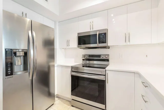 a kitchen with a refrigerator stove and microwave