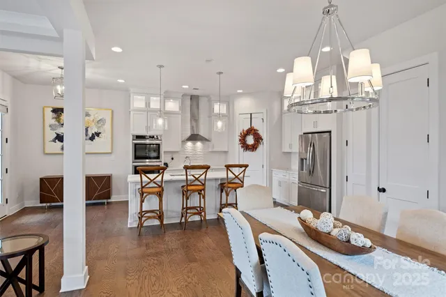 a large kitchen with a table and chairs