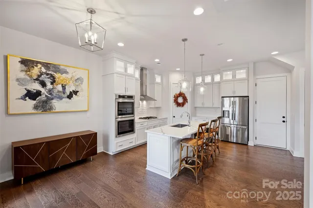 a view of a dining room with furniture wooden floor and a chandelier