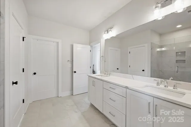 a spacious bathroom with a double vanity sink mirror and