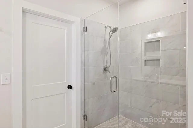 a bathroom with a shower and a glass door