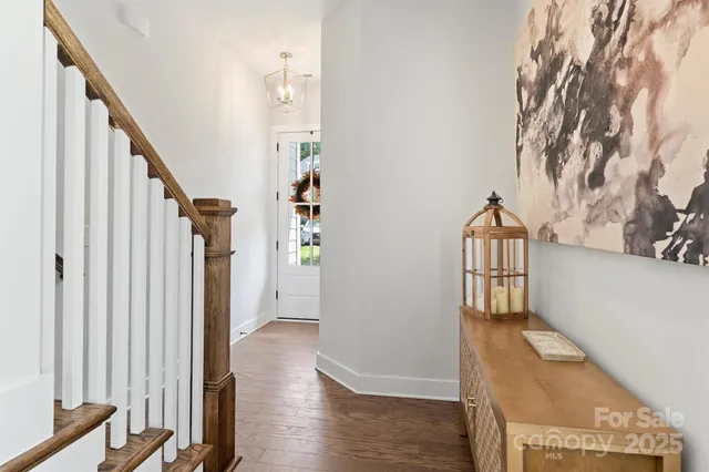 a view of entryway with wooden floor and stairs