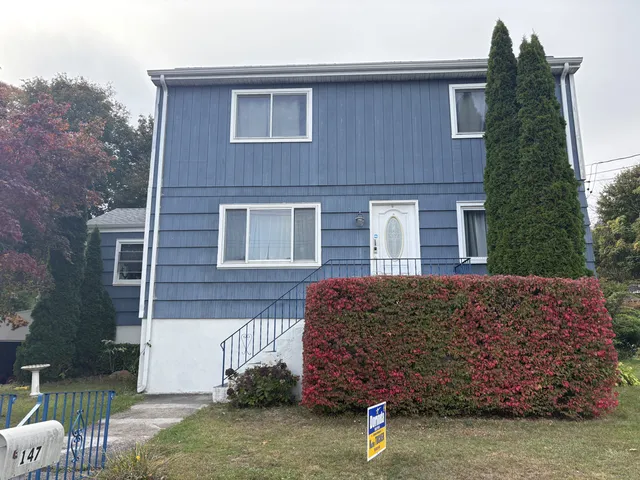 a front view of a house with a garden