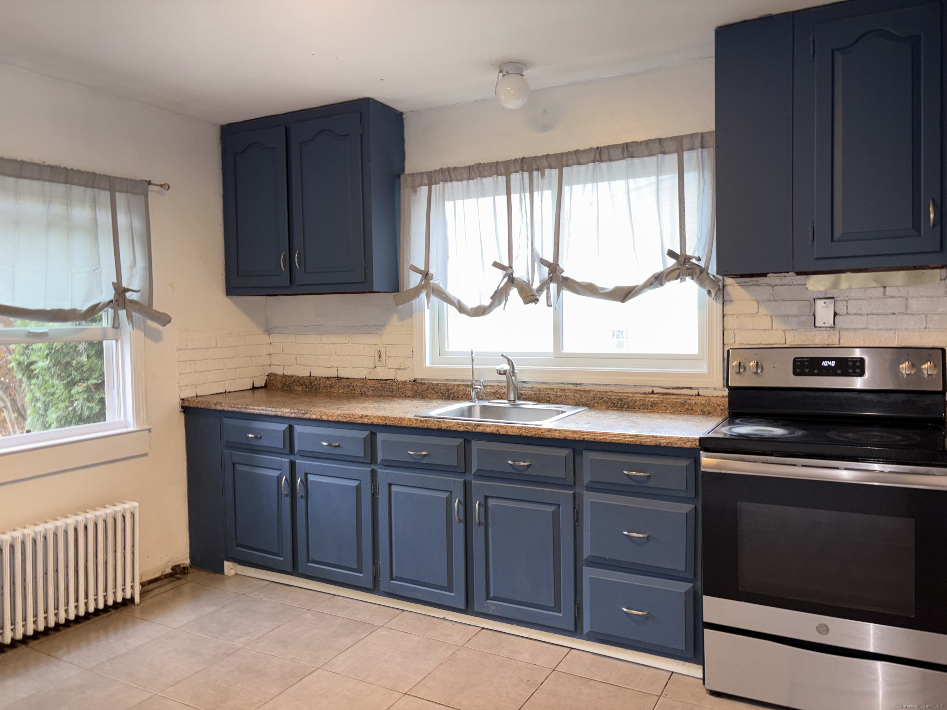 Undisclosed Address West Haven, CT 06516 - Photo 5 of 16 a kitchen with granite countertop wooden cabinets stainless steel appliances a sink and a window