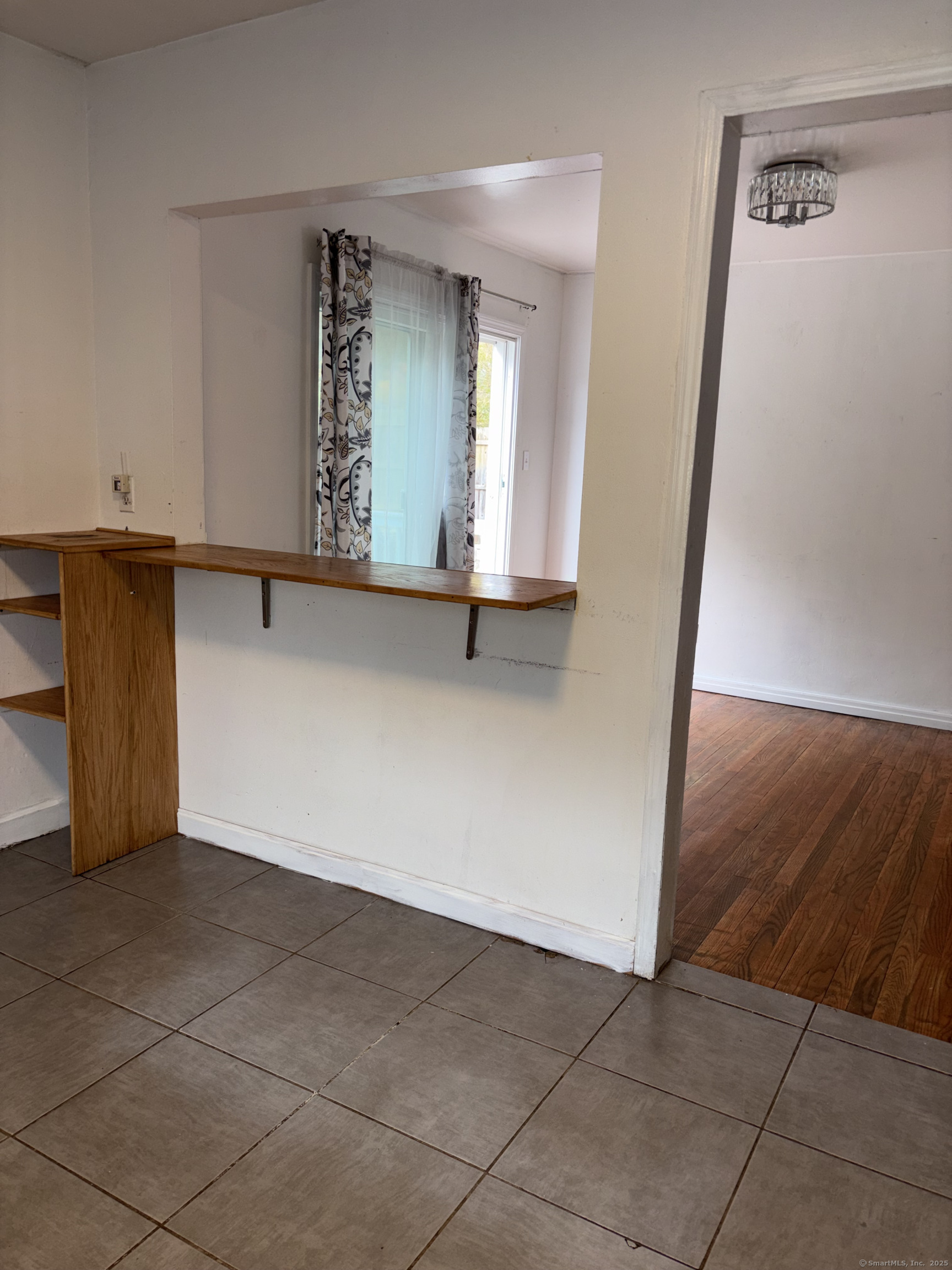 Undisclosed Address West Haven, CT 06516 - Photo 6 of 16 a view of a livingroom with wooden floor and cabinet