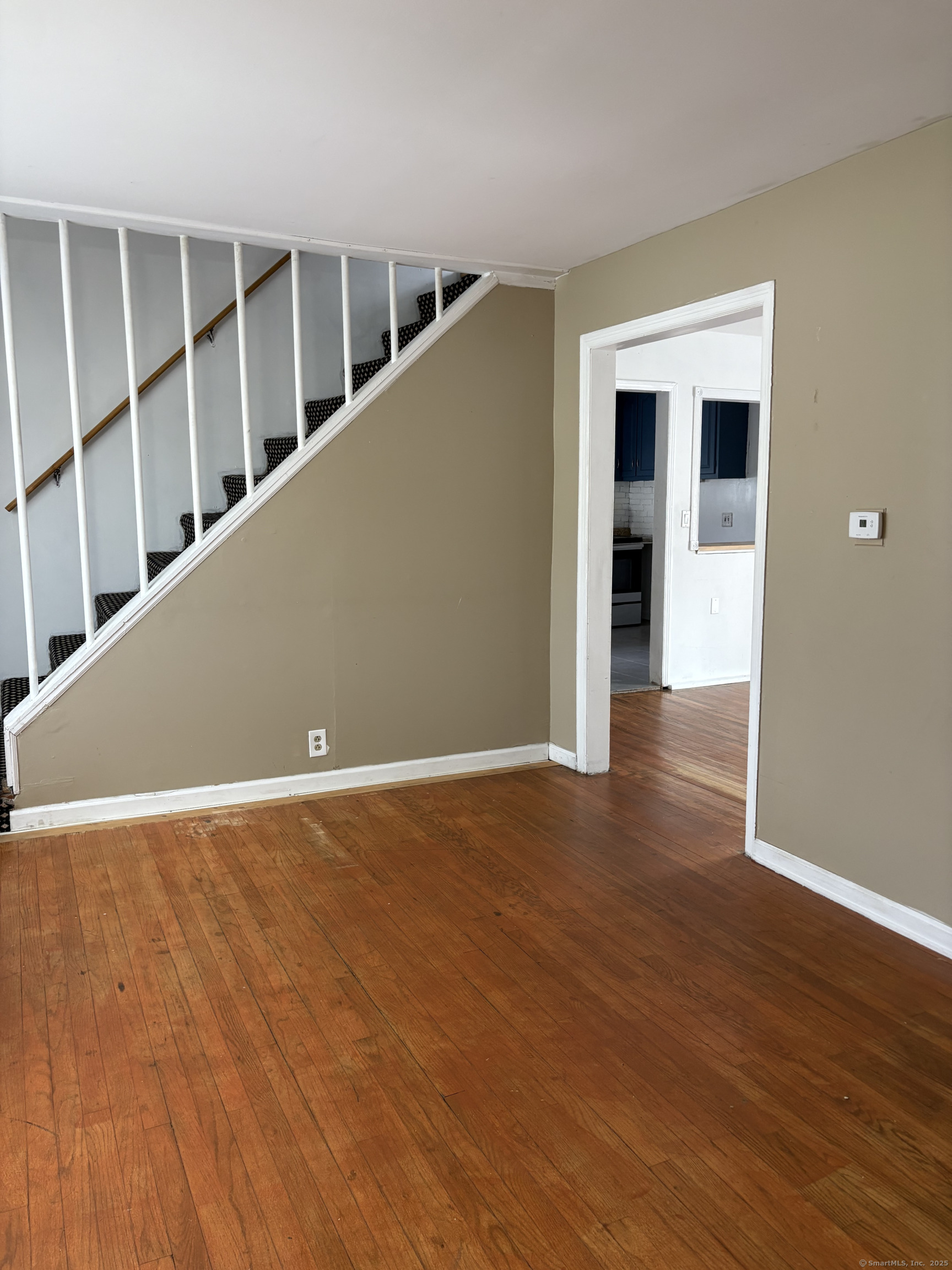 Undisclosed Address West Haven, CT 06516 - Photo 9 of 16 a view of an empty room with wooden floor and a window
