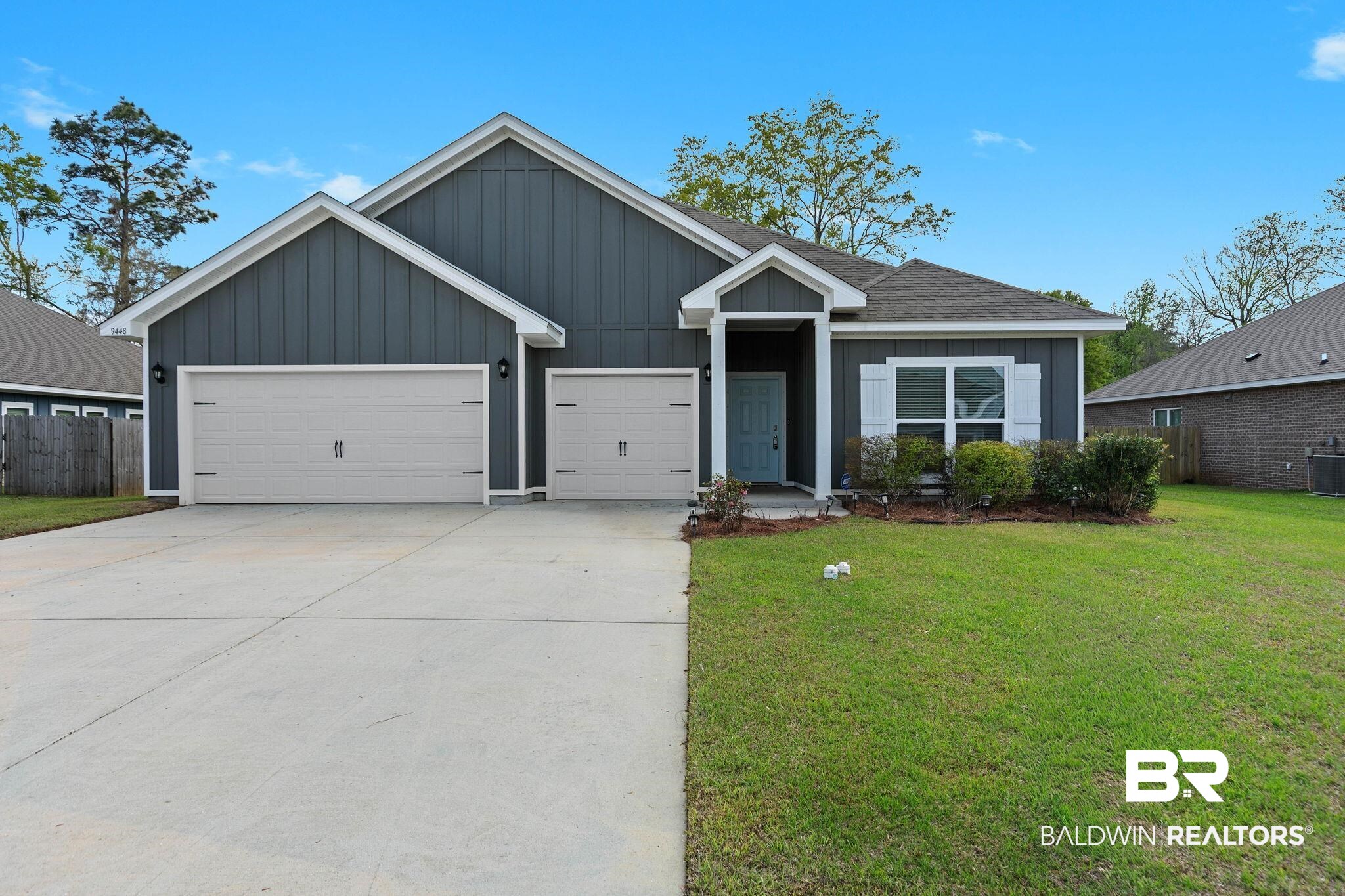 9448 Amethyst Drive Daphne, AL 36526 - Photo 1 of 61 Single story home with board and batten siding, concrete driveway, an attached garage, and roof with shingles