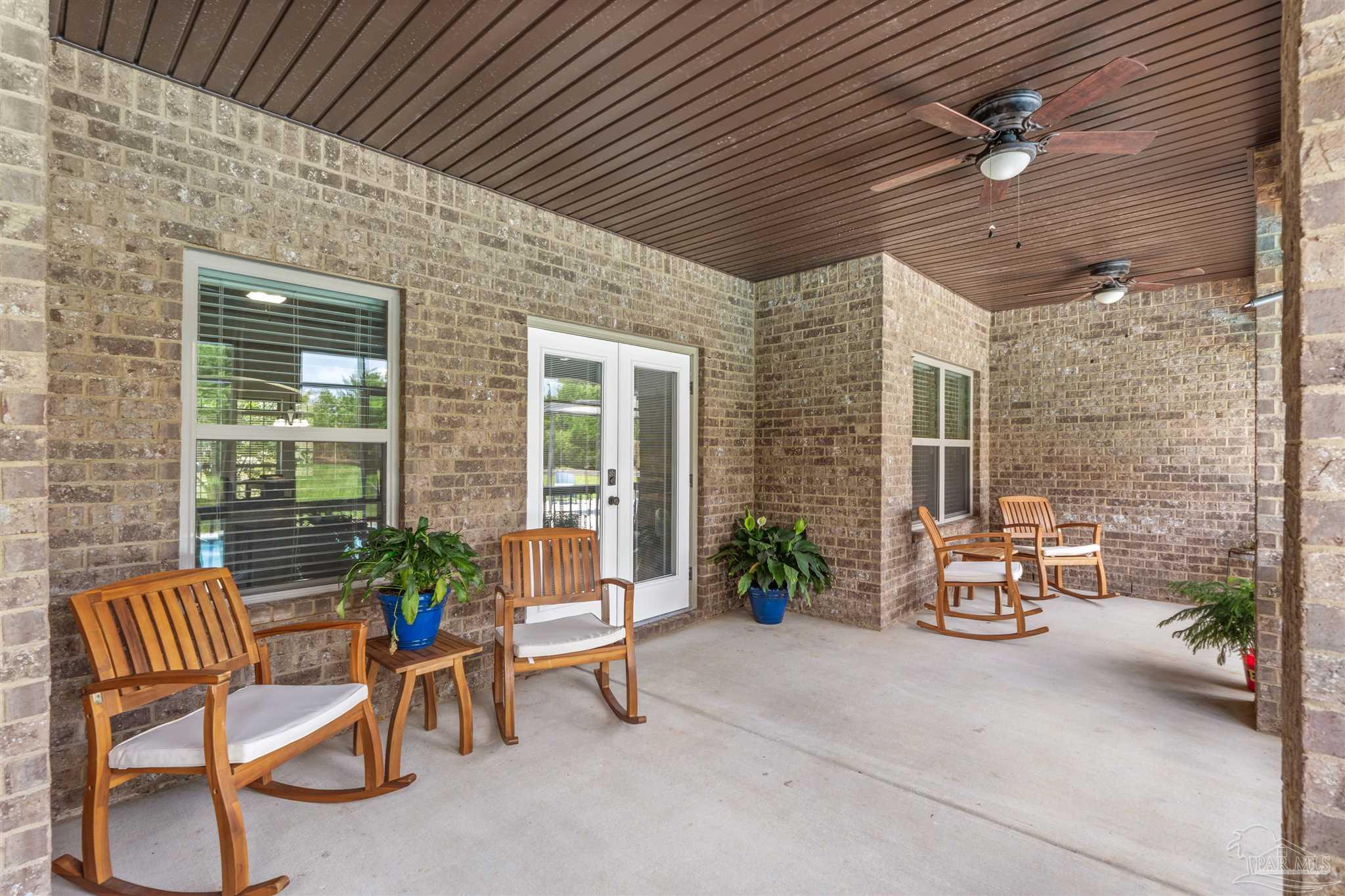 2698 Tulip Hill Road Pace, FL 32571 - Photo 52 of 65 a patio outdoor space with patio furniture and potted plants