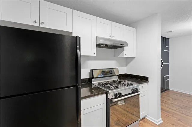 a kitchen with stainless steel appliances a refrigerator stove and microwave