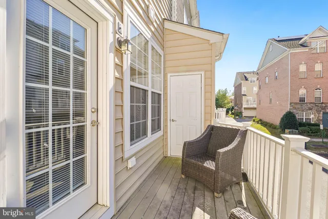 a view of deck with a chair and floor to ceiling window