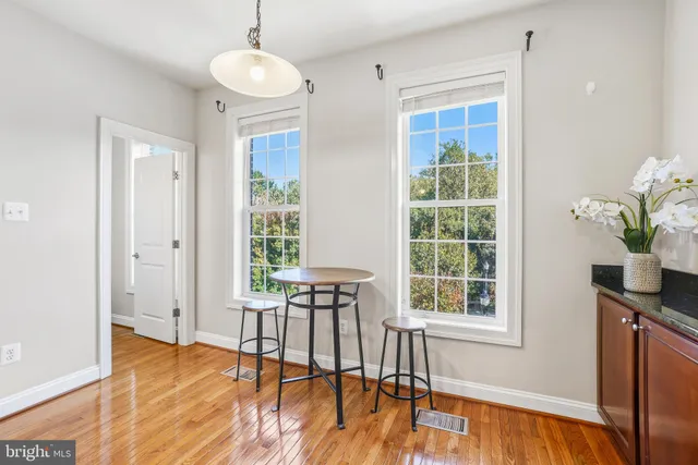 a view of a livingroom with furniture window and wooden floor