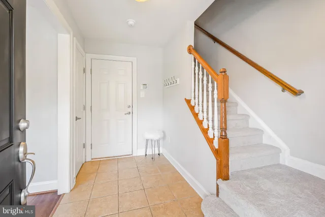 a view of entryway with wooden floor and stairs