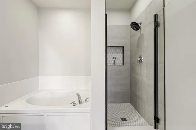 a bathroom with a tub and shower