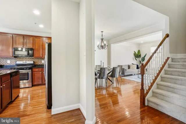 a view of kitchen with furniture and wooden floor