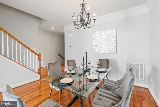 a view of a dining room with furniture wooden floor and a chandelier