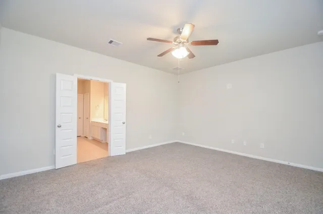 a view of a big room with closet and chandelier fan