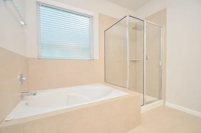 a bathroom with a bathtub and a shower