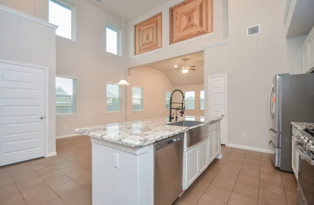a kitchen with a sink stove and refrigerator
