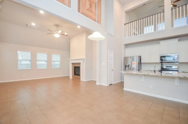 a view of a kitchen with kitchen island and stainless steel appliances