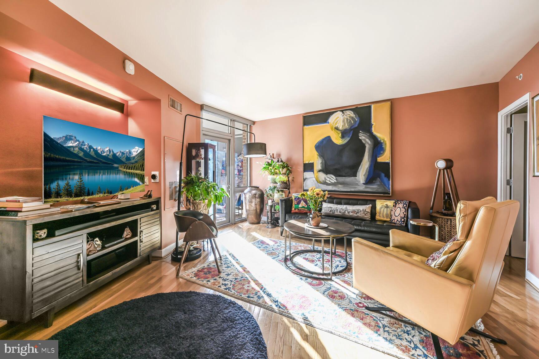 555 Massachusetts Avenue Northwest, Unit 901 Washington, DC 20001 - Photo 1 of 50 a living room with furniture a flat screen tv and a floor to ceiling window