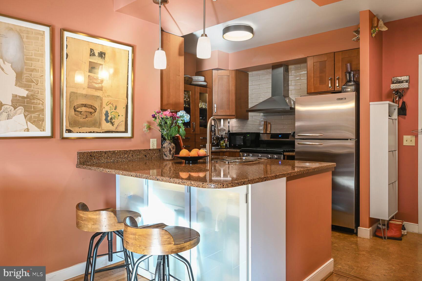 555 Massachusetts Avenue Northwest, Unit 901 Washington, DC 20001 - Photo 11 of 50 a kitchen with stainless steel appliances granite countertop a sink and a refrigerator