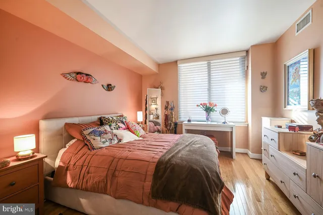 a bedroom with a large bed and a window