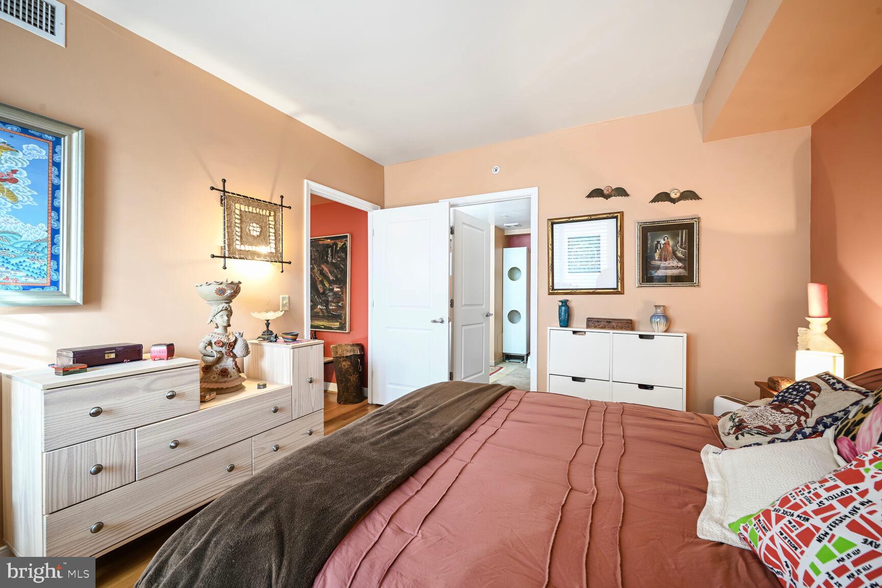 555 Massachusetts Avenue Northwest, Unit 901 Washington, DC 20001 - Photo 18 of 50 a bedroom with a bed and wooden floor