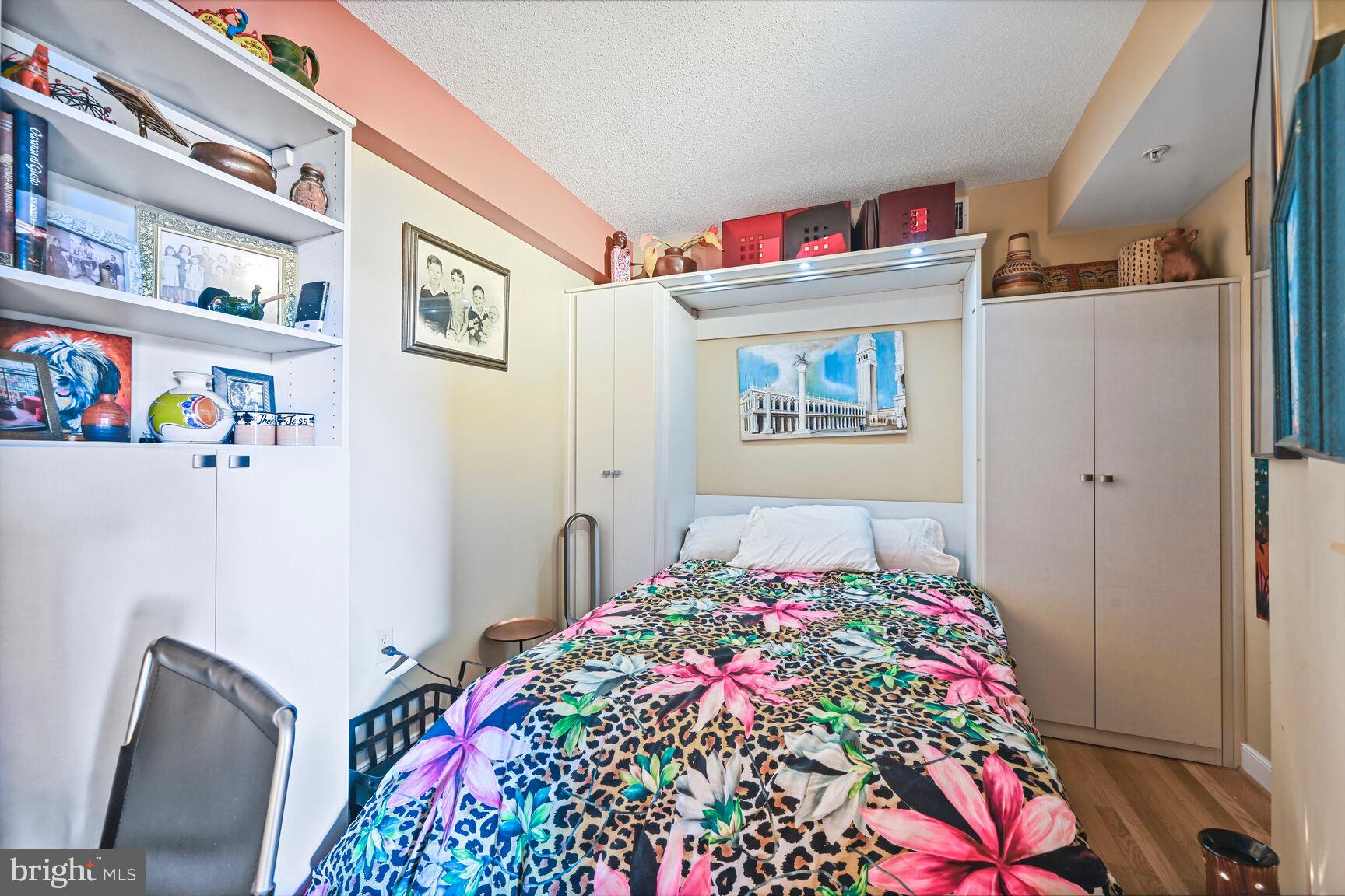 555 Massachusetts Avenue Northwest, Unit 901 Washington, DC 20001 - Photo 23 of 50 a bedroom with a bed and a dresser