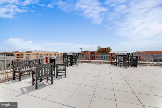 a view of roof deck with dining table and chair