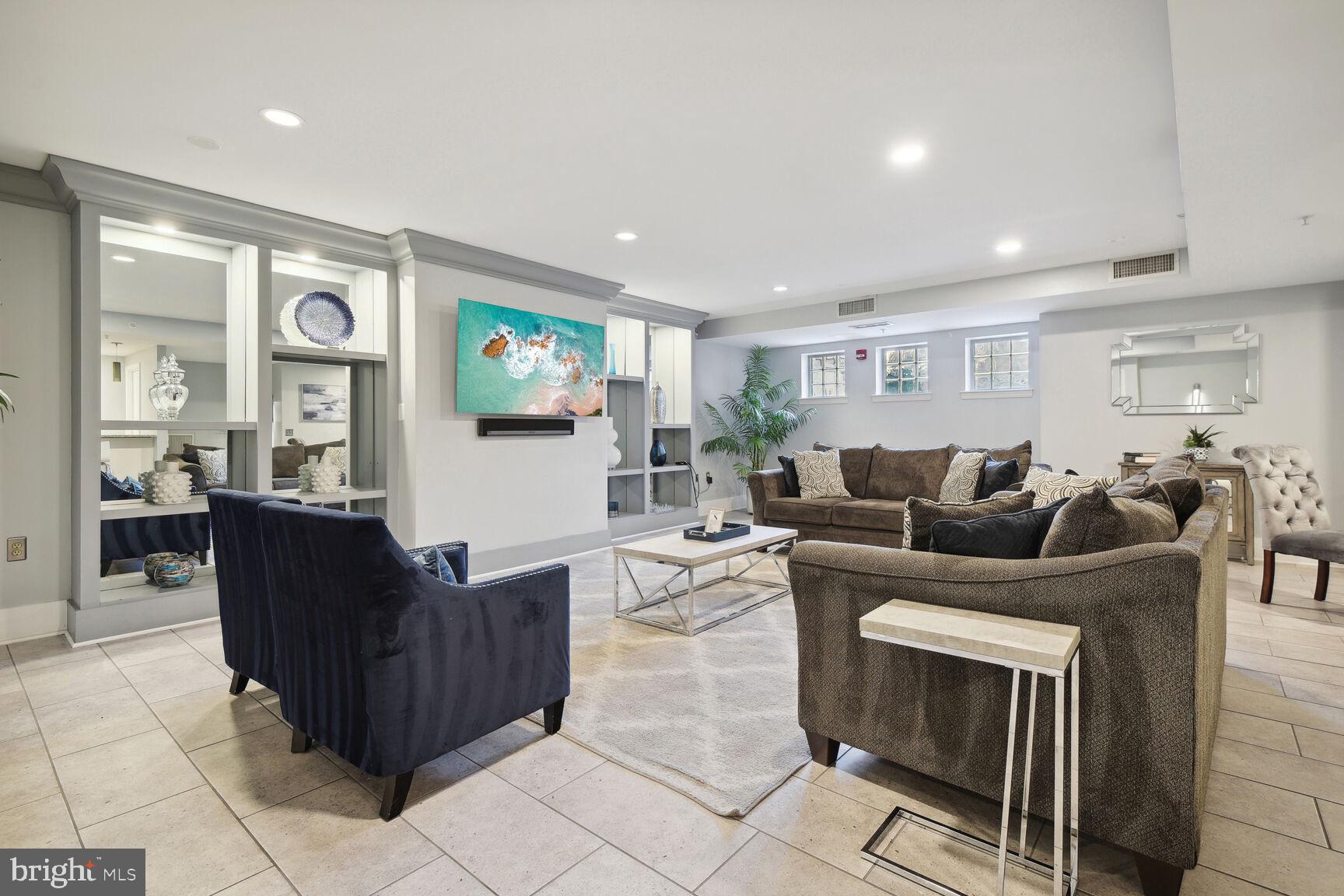555 Massachusetts Avenue Northwest, Unit 901 Washington, DC 20001 - Photo 41 of 50 a living room with furniture a window and a flat screen tv
