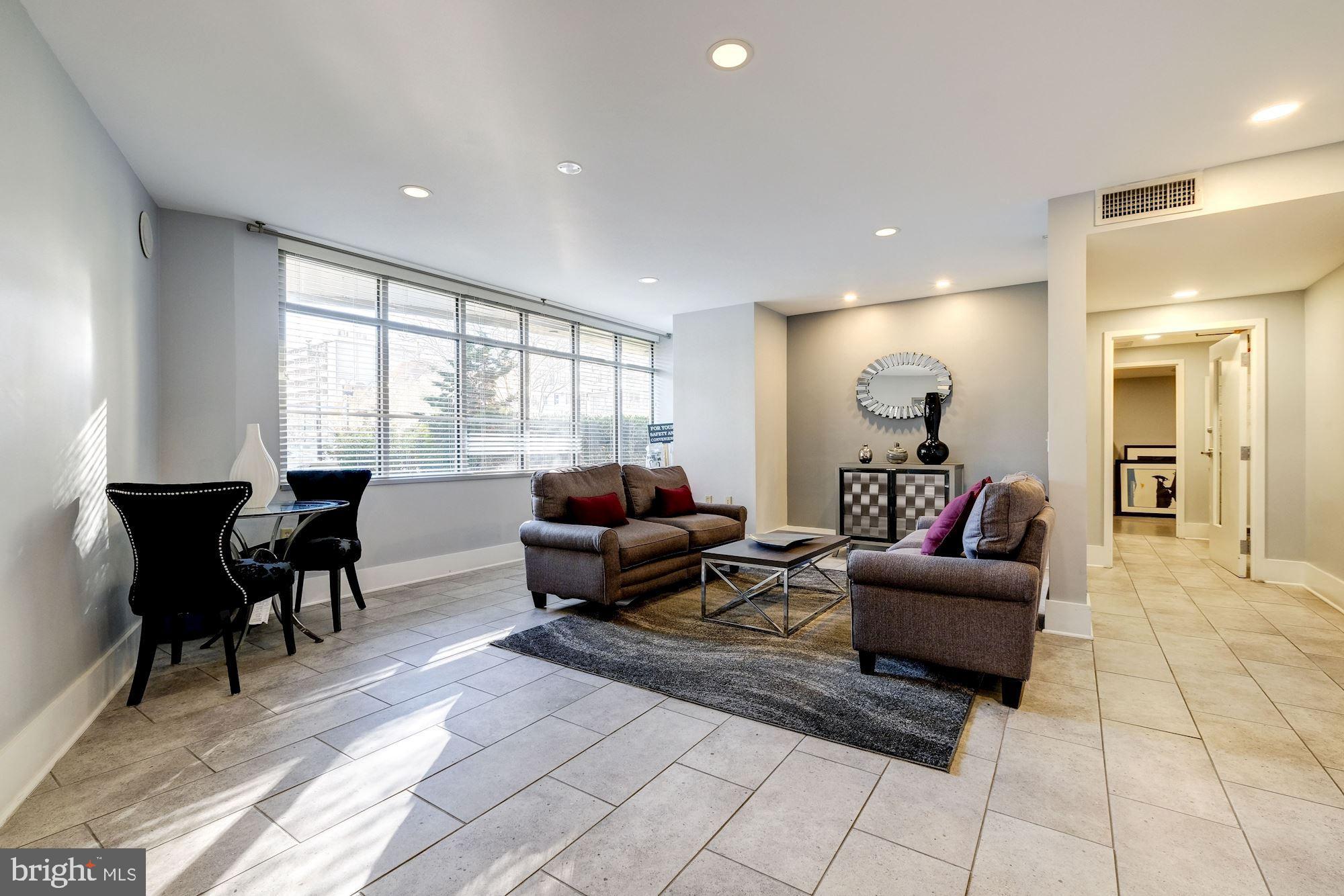 555 Massachusetts Avenue Northwest, Unit 901 Washington, DC 20001 - Photo 47 of 50 a living room with furniture and a large window