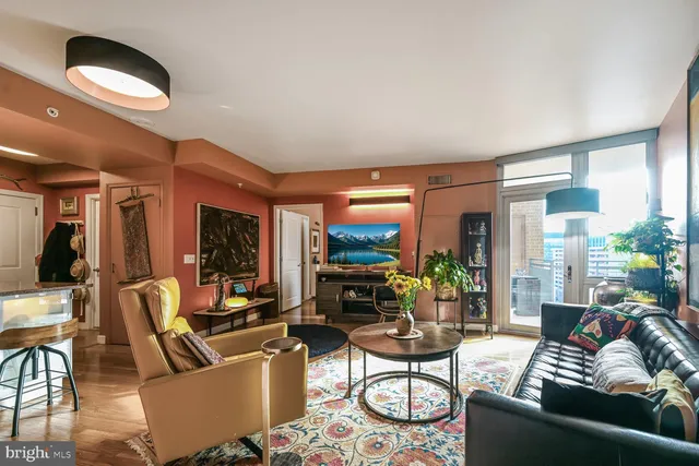 a living room with furniture and a floor to ceiling window