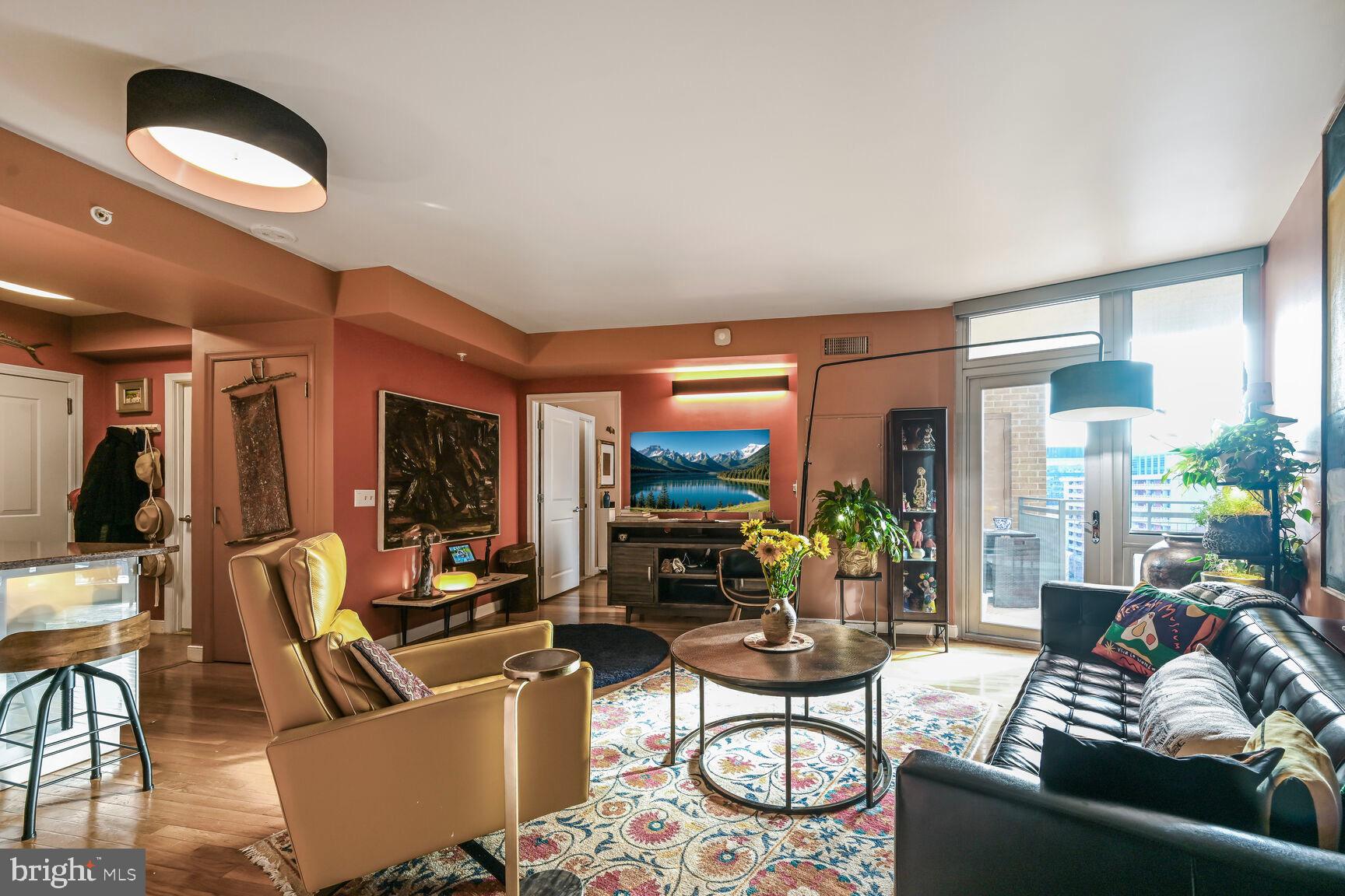 555 Massachusetts Avenue Northwest, Unit 901 Washington, DC 20001 - Photo 5 of 50 a living room with furniture and a floor to ceiling window